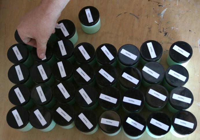 PHOTO BY MARIO BARTEL Labels are affixed to sample jars of FAT Paint.