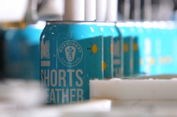 MARIO BARTEL/THE TRI-CITY NEWS Cans of Shorts Weather ISA, one of two new beers brewed by Moody Ales in collaboration with West Coast Canning, are filled on a portable canning machine on Monday.