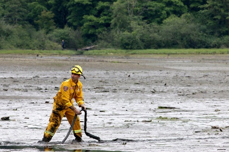 MARIO BARTEL/THE TRI-CITY NEWS A Port Moody firefighter deploys a 1.25-inch hose attached to a high-pressure spray gun that can be used to loosen the mud around a victim trapped in the mudflats at the eastern end of Port Moody Inlet.