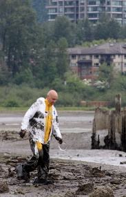 MARIO BARTEL/THE TRI-CITY NEWS Muddy but otherwise unhurt, Ron Suzukovich heads for solid ground after serving as the "victim" in a training exercise to help Port Moody firefighters rescue people trapped in the mudflats at the eastern end of Port Moody Inlet.