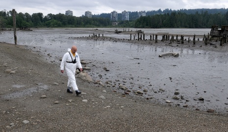MARIO BARTEL/THE TRI-CITY NEWS The designated "victim" for the exercise, Port Moody fire captain Ron Suzukovich, walks toward his doom in the mudflats off the Old Mill site on the north shore of Port Moody Inlet. Fire chief Ron Coulson says the easy access to the flats from shoreline trails and the proximity of many residents means his crews usually get called out twice a year to pluck people from the heavy muck.