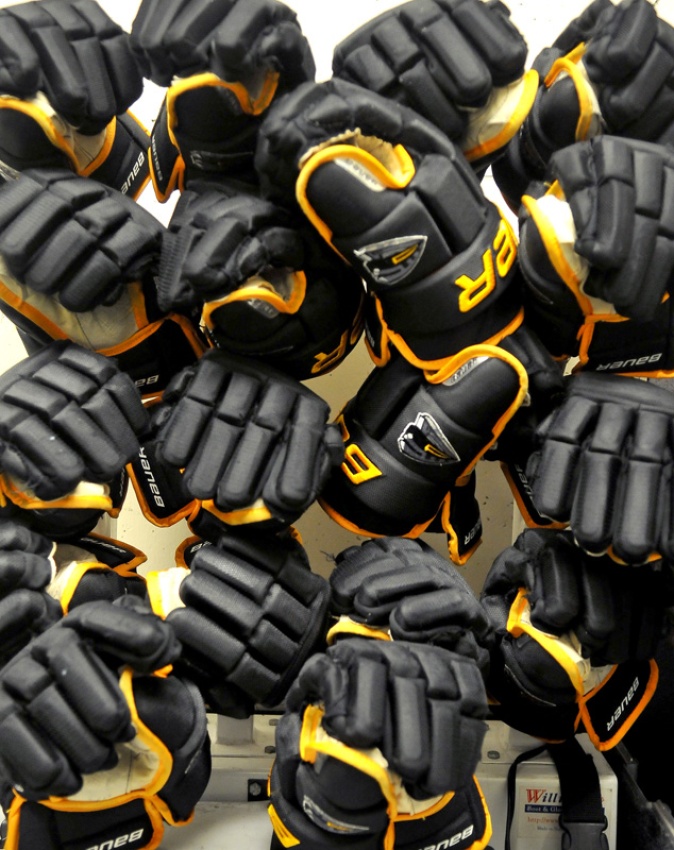 MARIO BARTEL/THE TRI-CITY NEWS Hockey gloves dry in a rack.