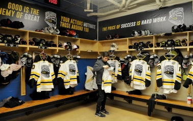 MARIO BARTEL/THE TRI-CITY NEWS Coquitlam Express trainer Ross Maceluch lays out uniforms and equipment for the players before their arrival for Wednesday's midday game against the Langley Rivermen.
