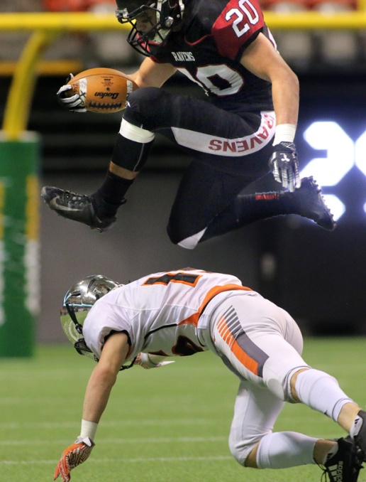 MARIO BARTEL/THE TRI-CITY NEWS Terry Fox Ravens full back Liam Cumarasamy leaps over a New Westminster Hyacks tackler in their BC Secondary Schools Football Association AAA Subway Bowl semi-final, Saturday at BC Place Stadium. New Westminster won the game, 33-0.