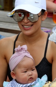 MARIO BARTEL/THE TRI-CITY NEWS Nancy Wong's beer is reflected in her sunglasses as she relaxes with her daughter, Joelle, 6 months.
