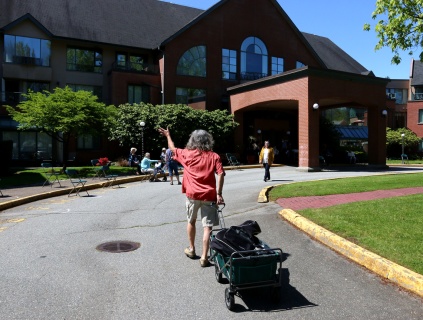 Chris Ridout waves to his fans and friends as he arrives to conduct a sing-a-long and yoga at Coquitlam's Parkwood Manor. Photograph By MARIO BARTEL/THE TRI-CITY NEWS